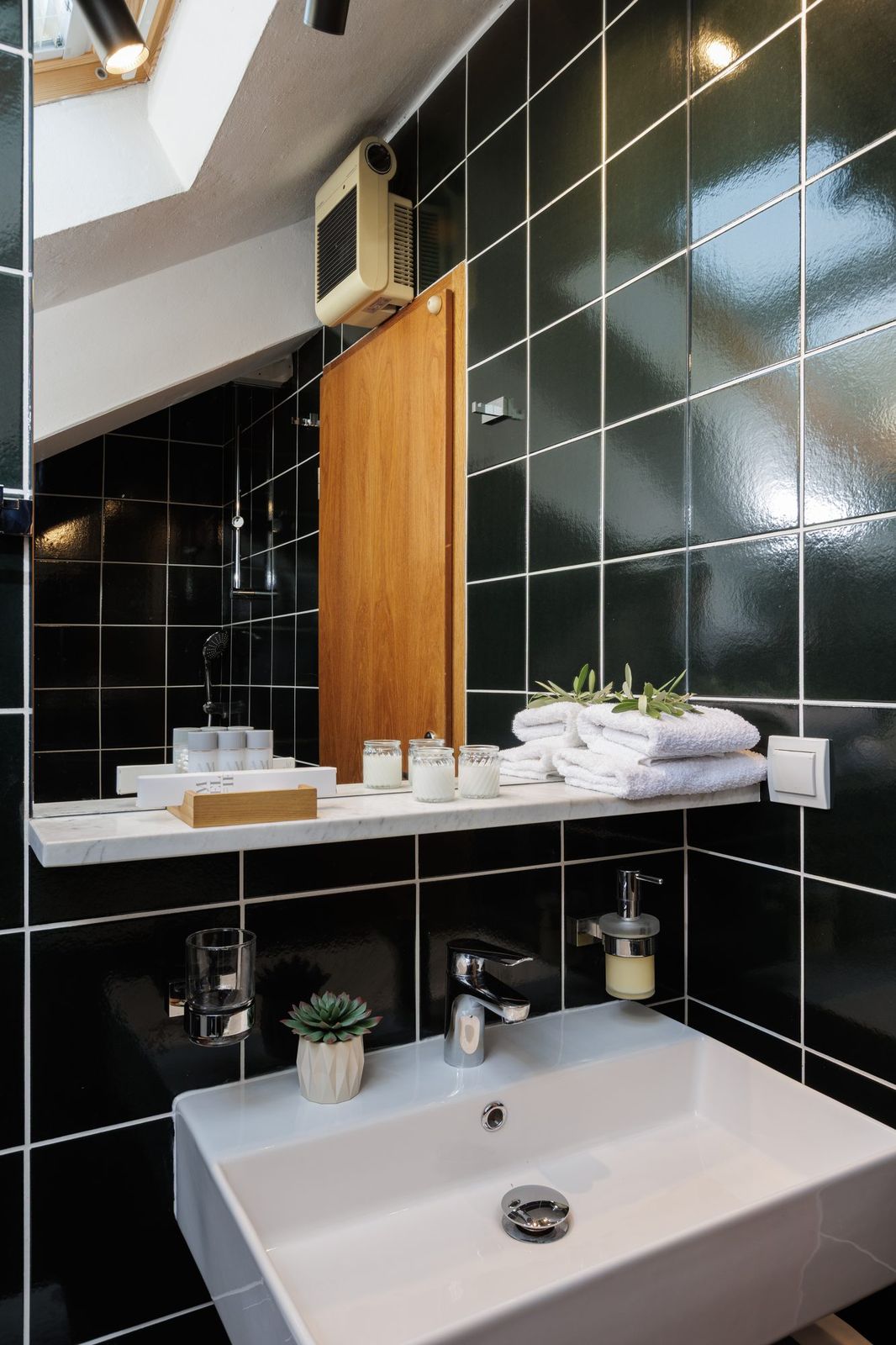 Attic bathroom, washbasin and marble top with a view from the skylight