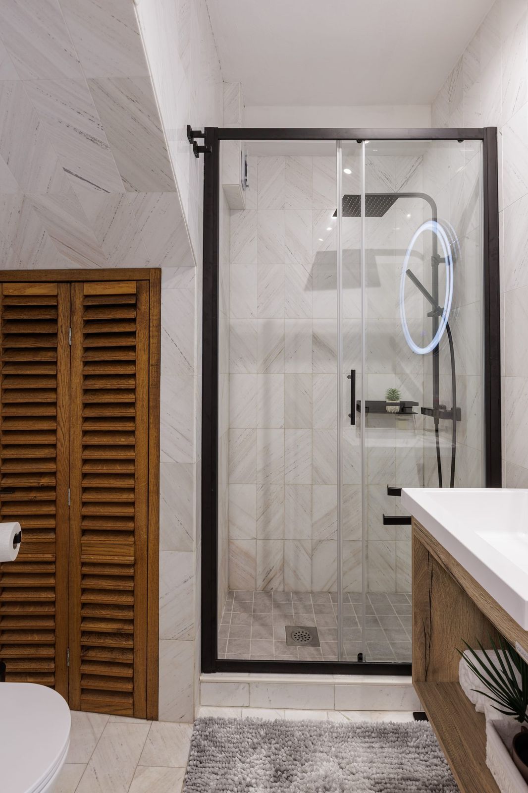 Modern bathroom, rain shower and round LED mirror